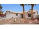 Single-story house with desert landscaping and two palm trees at 4527 Buddy Holly Ct, North Las Vegas, NV 89031