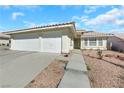 Single-story house featuring a two-car garage and well-maintained landscaping at 4722 Casa Bonita Dr, North Las Vegas, NV 89032