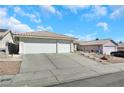 Two-car garage, spacious driveway, and neatly kept front yard at 4722 Casa Bonita Dr, North Las Vegas, NV 89032