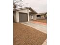 House exterior featuring a single-car garage and a gravel driveway at 4928 Nellie Springs Ct, Las Vegas, NV 89110