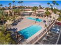 Aerial view of refreshing community pool area with palm trees at 5080 Indian River Dr # 403, Las Vegas, NV 89103