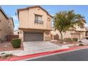 Two-story house with attached garage and landscaped front yard at 5916 Magic Oak St, North Las Vegas, NV 89031