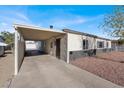 Front view of a charming house featuring a carport and manicured yard at 649 Federal St, Henderson, NV 89015