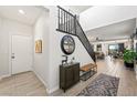 Bright foyer with tile floors, staircase, and stylish decor, offering a welcoming entrance at 7073 Range Valley St, North Las Vegas, NV 89084