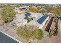 Aerial view of a well-maintained house with desert landscaping and solar panels on the roof at 7288 Olsen Farm St, Las Vegas, NV 89131