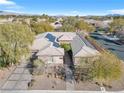 Expansive aerial view of home featuring solar panels, desert landscaping, and a well-maintained roof and driveway at 7288 Olsen Farm St, Las Vegas, NV 89131