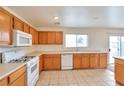 Spacious kitchen featuring wood cabinets, and modern appliances at 7732 Prosperity River Ave, Las Vegas, NV 89129