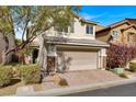 Two-story house with a two-car garage and landscaped front yard at 8960 Fox Season Ave, Las Vegas, NV 89178