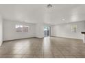 Spacious living room with tile floors and access to backyard at 8960 Fox Season Ave, Las Vegas, NV 89178