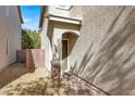 Side entrance to the house with a small, paved walkway at 8960 Fox Season Ave, Las Vegas, NV 89178