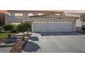 Two-story house with a three-car garage and landscaped front yard at 9123 Claretta Dr, Las Vegas, NV 89129