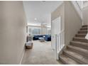 Bright and spacious hallway with carpeted stairs leading to upper level at 9289 Casa Sierra Ln, Las Vegas, NV 89148