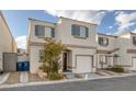 Two-story house with attached garage and landscaping at 10009 Delicate Dew St, Las Vegas, NV 89183