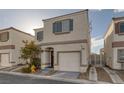 Two-story house with attached garage and landscaping at 10009 Delicate Dew St, Las Vegas, NV 89183