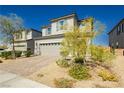 Two-story house with gray siding, gray shutters, and landscaping at 1004 Huckburn Ave, Henderson, NV 89015