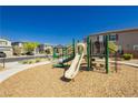 Community playground with playset and wood-chip surface at 1004 Huckburn Ave, Henderson, NV 89015