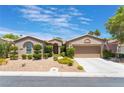 Single story home with two car garage and well manicured landscaping at 10452 Acclamato Ave, Las Vegas, NV 89135