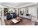 Open concept living room featuring a modern fireplace and comfortable seating at 10452 Acclamato Ave, Las Vegas, NV 89135