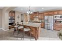 Spacious kitchen with stainless steel appliances and a large center island with barstool seating at 1067 Via Saint Andrea Pl, Henderson, NV 89011