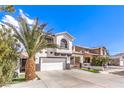 Two-story house with white exterior, red accents, and a two-car garage at 1144 Sage Valley Ct, Las Vegas, NV 89110