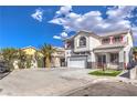 Two-story house with white exterior, red accents, and a two-car garage at 1144 Sage Valley Ct, Las Vegas, NV 89110