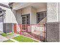 Front entrance with red wrought iron gate and screen door at 1144 Sage Valley Ct, Las Vegas, NV 89110