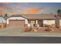 One-story house with a brown garage door and landscaped front yard at 1226 Sunfire St, Henderson, NV 89014