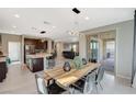 Bright dining area flows into the kitchen and Gathering room, with sliding doors for indoor/outdoor living at 12898 Slipknot St, Las Vegas, NV 89141