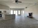 Open living room with tile floors and stone fireplace at 1400 Equestrian Ct, Pahrump, NV 89048