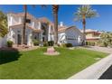 Landscaped front yard with lush green grass and large rocks at 1613 Iron Ridge Dr, Las Vegas, NV 89117