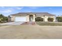 House exterior featuring a single-story home with a front yard and attached garage at 1920 Cavalry St, Pahrump, NV 89048