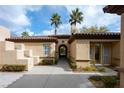 Spanish style home with arched entryway and courtyard at 2475 Grassy Spring Pl, Las Vegas, NV 89135