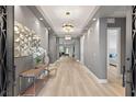 Bright and spacious entryway with elegant light fixtures and modern flooring at 2669 Pioneer Estates Ct, Las Vegas, NV 89117