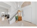 Bright and spacious entryway with tiled floors and staircase at 2682 Korea Ct, Henderson, NV 89052