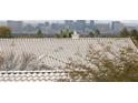 Close-up view of the tile roof with a city skyline in the background at 2682 Korea Ct, Henderson, NV 89052