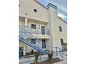 Two-story condo building with stairs and desert landscaping at 2725 S Nellis Blvd # 2036, Las Vegas, NV 89121