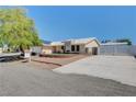 House exterior with a spacious driveway and neatly landscaped front yard at 303 Glasgow St, Henderson, NV 89015