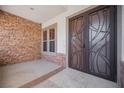 Front entry with stone accent wall and double doors at 328 Hedgehope Dr, Las Vegas, NV 89183