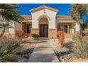 Front entry featuring a stone accent wall and decorative iron doors at 328 Hedgehope Dr, Las Vegas, NV 89183