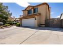 Two-story house with a white garage door and gated driveway at 3817 W Red Coach Ave, North Las Vegas, NV 89031