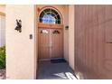 Double front doors with arched window and decorative hardware at 3817 W Red Coach Ave, North Las Vegas, NV 89031