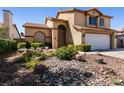 Landscaped front yard with rocks and drought-tolerant plants at 3817 W Red Coach Ave, North Las Vegas, NV 89031