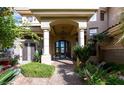 Elegant entryway with arched columns and lush landscaping at 4 Bloomfield Hills Dr, Henderson, NV 89052