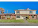 Charming two-story home with a brick and siding exterior, complemented by a lush green lawn and mature landscaping at 4008 Snead Dr, Las Vegas, NV 89107