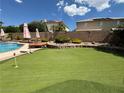 Landscaped backyard putting green with seating area at 420 Rhythm St, Henderson, NV 89074