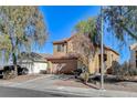 Two-story house with attached garage and well-maintained landscaping at 422 Waterbrook Dr, Henderson, NV 89015