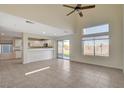 Open-concept living room featuring tile flooring, high ceilings, and a sliding glass door at 422 Waterbrook Dr, Henderson, NV 89015