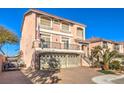 Two-story house with a two car garage and palm trees at 5490 Tulip Hill Ave, Las Vegas, NV 89141