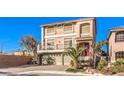 Two-story house with a two car garage and palm trees at 5490 Tulip Hill Ave, Las Vegas, NV 89141