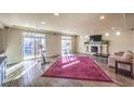 Spacious living room featuring fireplace, hardwood floors, and natural light at 5490 Tulip Hill Ave, Las Vegas, NV 89141